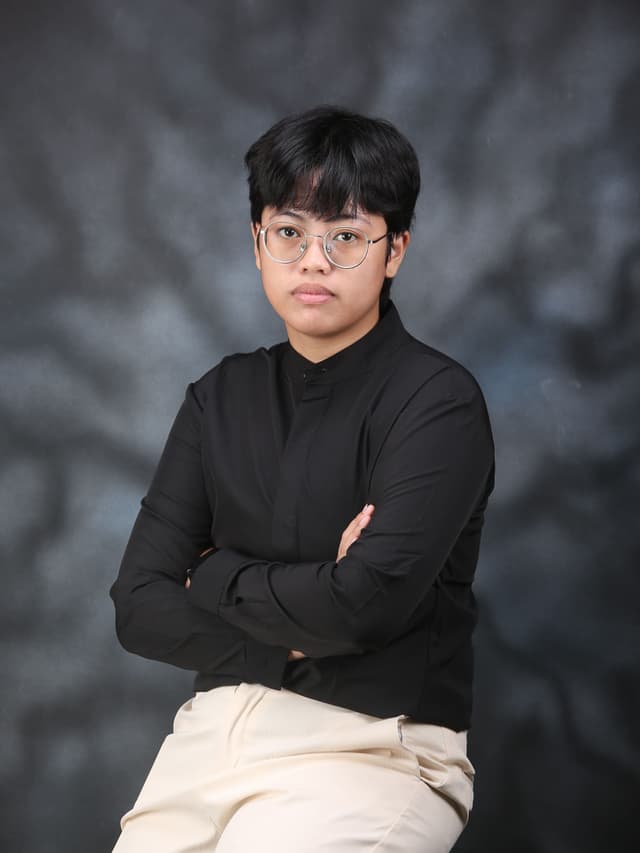 Portrait of Trisha “Ash” Capitle, full-stack software engineer